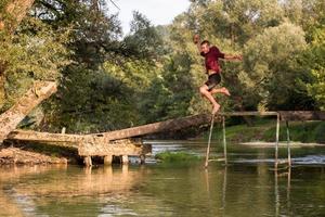 man jumping into the river photo