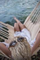 blonde woman resting on hammock photo