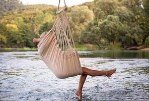 blonde woman resting on hammock photo