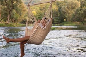 blonde woman resting on hammock photo