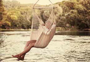 blonde woman resting on hammock photo