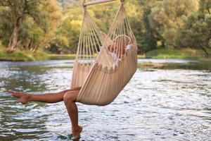 blonde woman resting on hammock photo