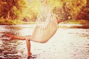 blonde woman resting on hammock photo