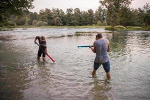 young men having fun with water guns photo