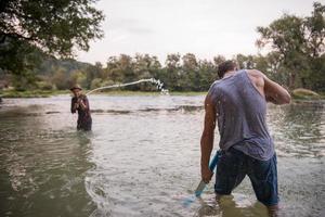 young men having fun with water guns photo