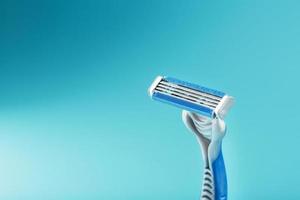 Blades of a new shaving machine on a blue background photo