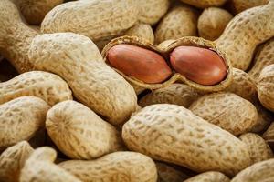 Peeled peanut on well peanuts. Peanuts, for background or textures. photo