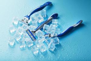 Refreshing shaving machines for the face against the background of frosty ice cubes photo