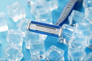 Refreshing shaving machines for the face against the background of frosty ice cubes photo