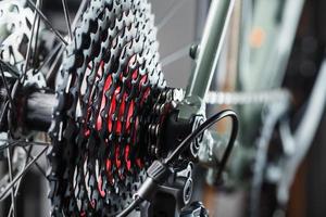 Black bicycle 11-speed cassette with switch and chain close-up, accessories for bike repair and tuning photo