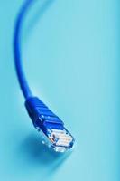 Blue UTP Internet Cable Isolated on a blue background Ethernet Cord photo