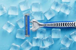 Refreshing shaving machines for the face against the background of frosty ice cubes photo