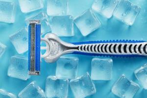Refreshing shaving machine on the background of frosty ice cubes without irritation photo