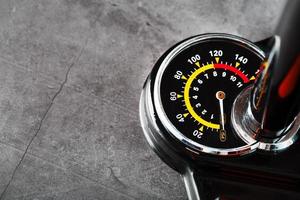 Air pump manometer for monitoring tire pressure on a dark background with free space photo