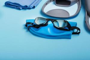 Sports equipment for swimming in the pool and open water on a blue background photo