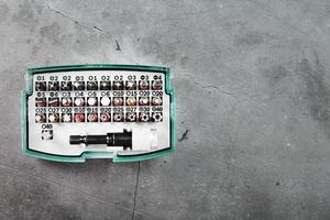 A set of metal power bits in a box on a gray background photo