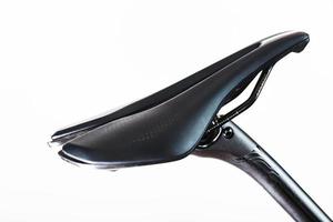 Bicycle saddle with seatpost on a light background accessories for bike repair and tuning photo