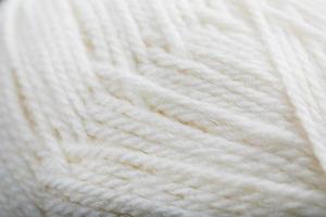 White threads of natural wool close-up in full screen photo