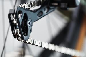 Black bicycle 11-speed cassette with switch and chain close-up, accessories for bike repair and tuning photo