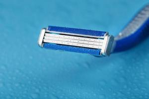 Shaving machine for the face on a blue background top view free space photo