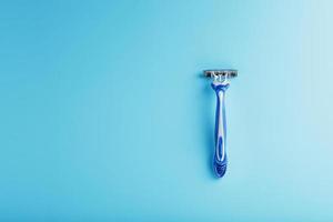 Shaving machine for the face on a blue background top view free space photo