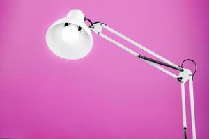 Classic table lamp on pink background with space for text and idea concept photo