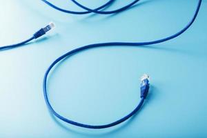 Blue Ethernet Cable Cord Patch cord on a blue background with free space photo
