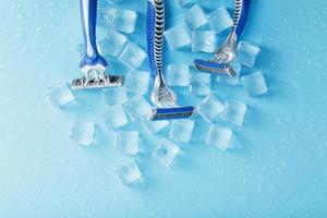 Refreshing shaving machines for the face against the background of frosty ice cubes photo