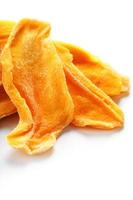 Dried sweet mango fruit slices as textural orange photo