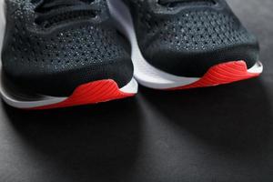 Black sports sneakers for training on a dark background photo