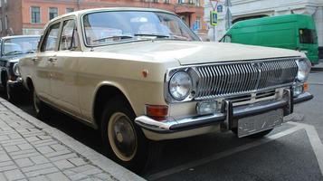 Car Volga car parked on the street, gas station in the background photo