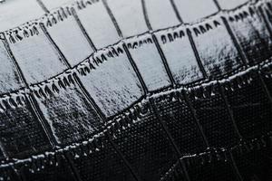 Texture of black crocodile skin in the background in full screen photo