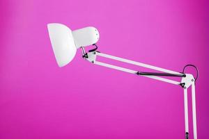 Classic table lamp on pink background with space for text and idea concept photo