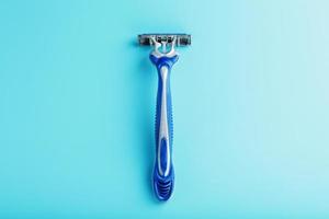 Shaving machine for the face on a blue background top view free space photo