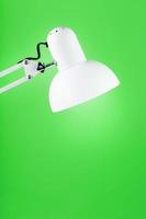 Office table lamp on green background with space for text and idea concept photo