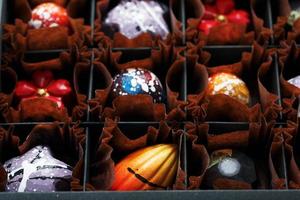 surtido de chocolates dulces hechos a mano en una caja foto