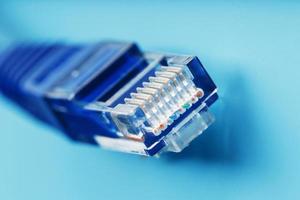 Ethernet Cable connector Patch cord cord close-up on a blue background with free space photo