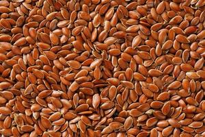 Background texture of seeds of dark brown flax. photo