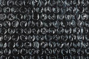 The texture of the packaging air-bubble film on a Black background in full screen photo