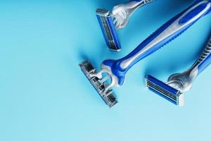 Blue shaving machines in a row on a blue background with ice cubes photo