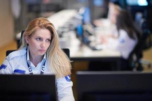 Female operator working in a security data system control room photo
