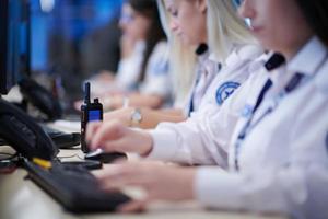 Female security guards working in a security data system control room photo