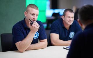 Group of security guards sitting and having briefing photo