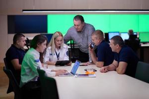 Group of security guards sitting and having briefing photo