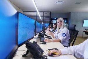 Female security guards working in a security data system control room photo