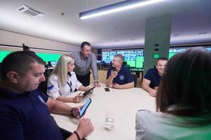 Group of security guards sitting and having briefing photo