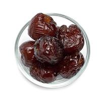 Chinese date or Jujube or monkey apple in syrup with glass bowl isolated on white background photo