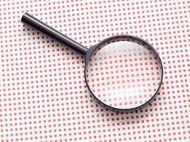 magnifying glass on table photo