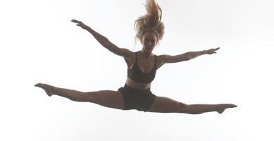 bailarina de ballet deportivo femenino delante de un fondo blanco foto