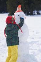 boy making snowman photo